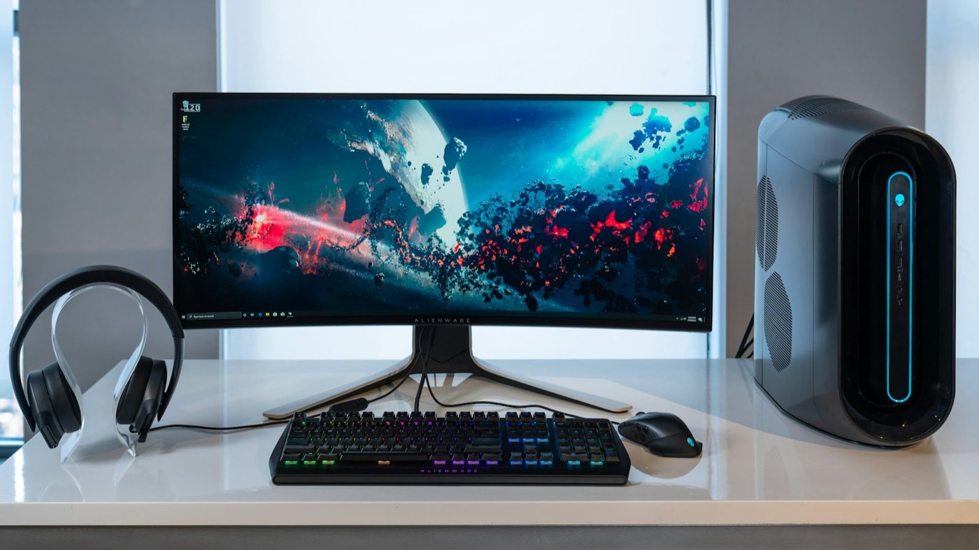 Desktop computer with curved monitor, keyboard and mouse